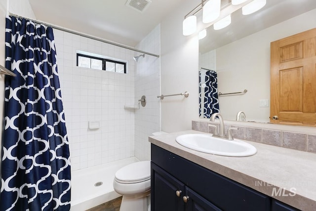 8315 Elk Ridge Ln, Middleton, ID 83644 - bathroom with vanity, toilet, and a tile shower