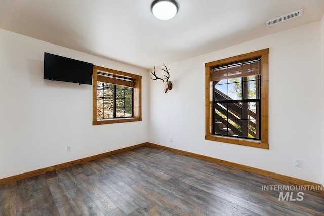 8315 Elk Ridge Ln, Middleton, ID 83644 - empty room with healthy amount of natural light, baseboards, and dark wood-type flooring