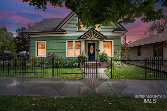 view of front of house with a front yard and a fenced front yard