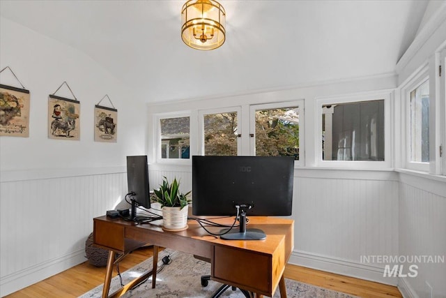 office space with wainscoting, plenty of natural light, and wood finished floors