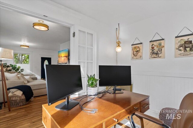 office with a wainscoted wall and wood finished floors