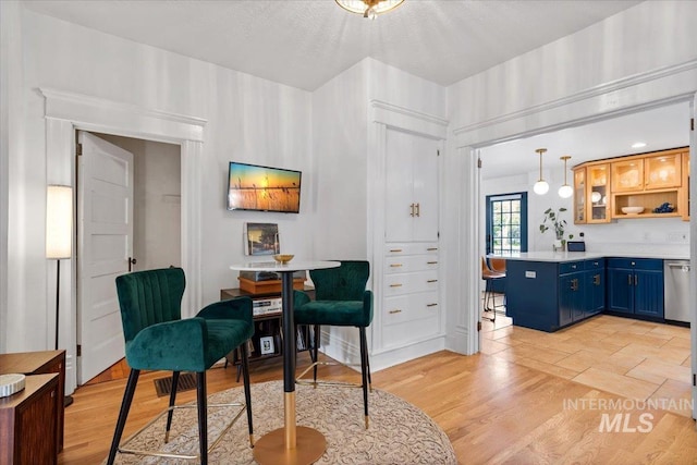 sitting room featuring a textured ceiling and light wood-style flooring