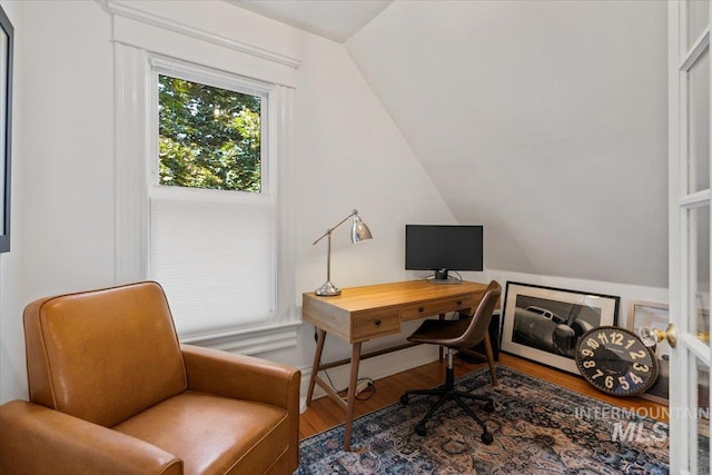 office space with lofted ceiling and wood finished floors