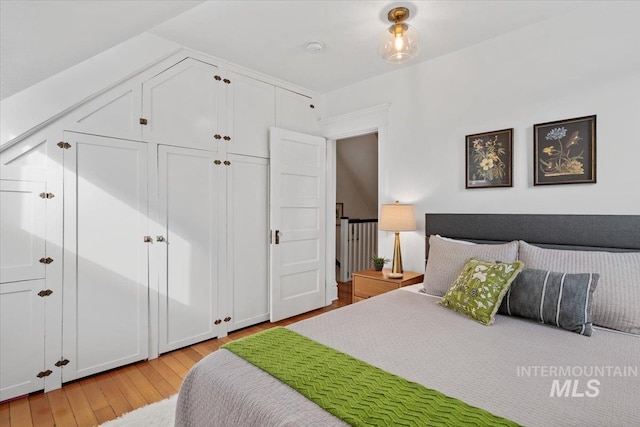 bedroom featuring a closet and light wood-type flooring