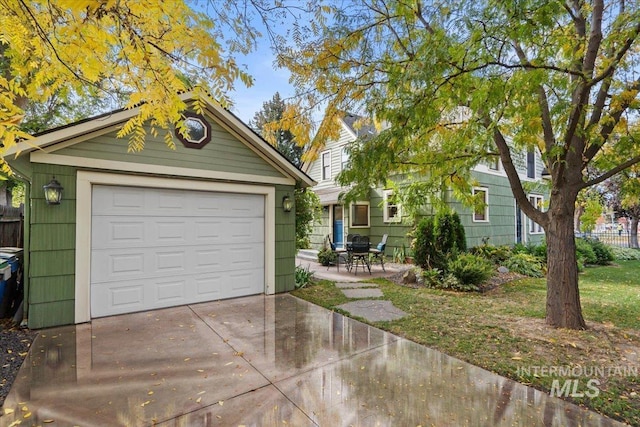 detached garage with driveway and fence