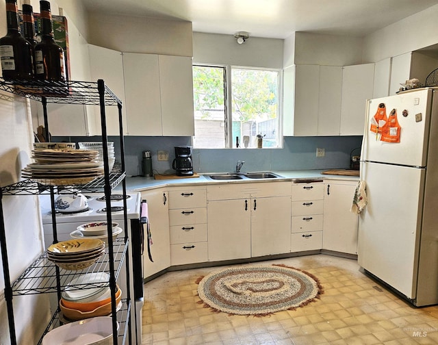 606 24th St, Lewiston, ID 83501 - kitchen with freestanding refrigerator, a sink, electric range oven, light floors, and light countertops