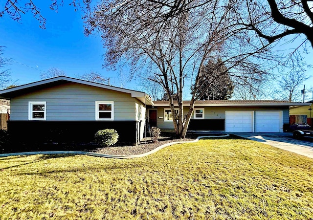 ranch-style house featuring a garage and a front lawn