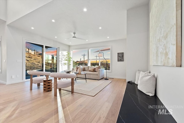 living room featuring light wood-style floors, recessed lighting, baseboards, and a ceiling fan