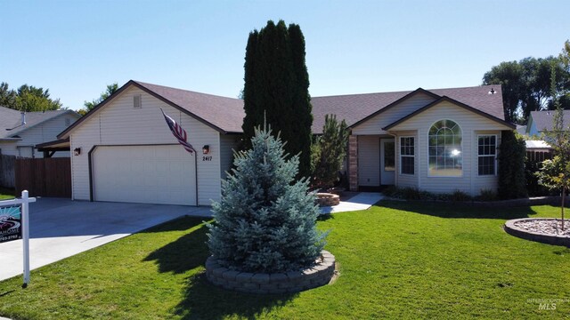 ranch-style house featuring a garage and a front lawn