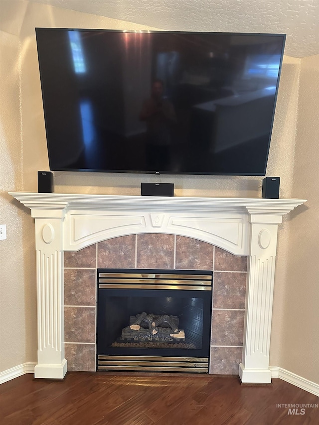 interior details featuring a fireplace and hardwood / wood-style floors