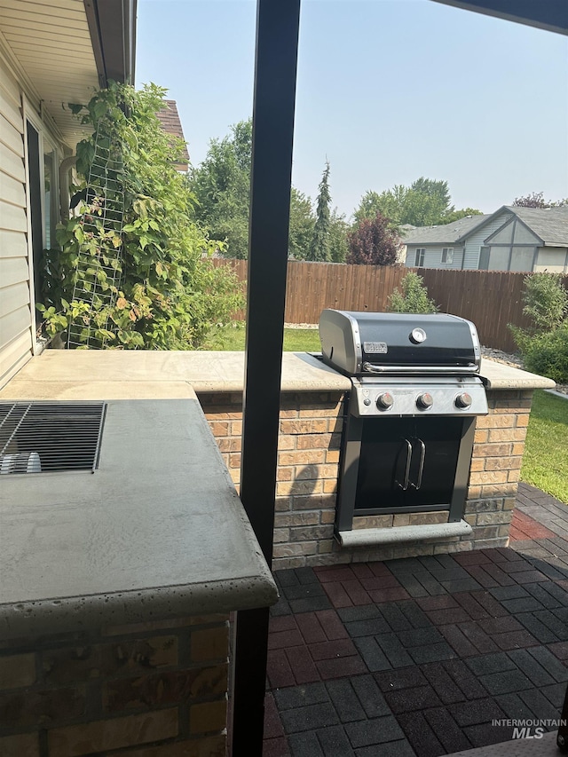 view of patio with an outdoor kitchen and area for grilling