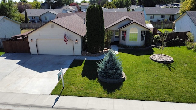 view of front of house with a garage and a front lawn