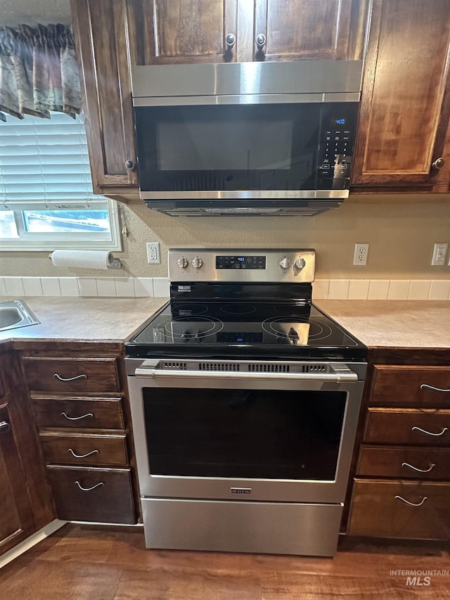 kitchen featuring dark brown cabinetry and stainless steel appliances