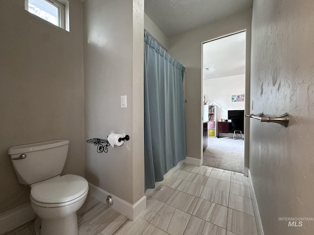 full bathroom with toilet, baseboards, and a shower with shower curtain