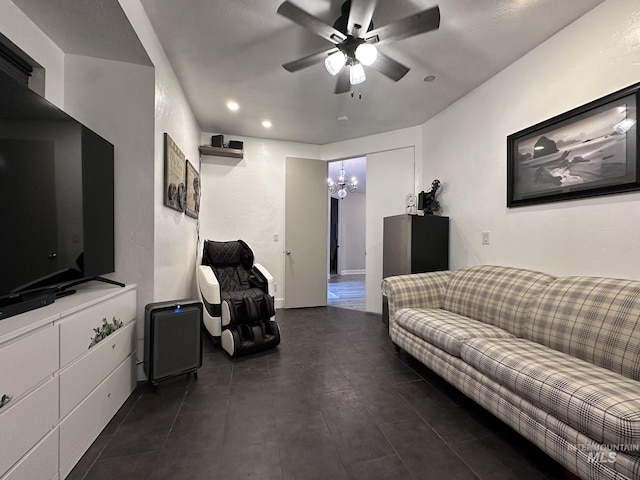 living area featuring recessed lighting and ceiling fan with notable chandelier