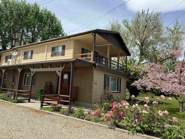 view of front of property featuring a balcony and covered porch