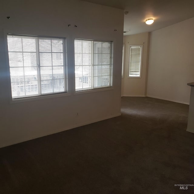 empty room with carpet flooring and baseboards