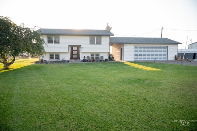 193 S 500 W, Paul, ID 83347 - bi-level home featuring a front yard, a detached garage, an outbuilding, and a chimney