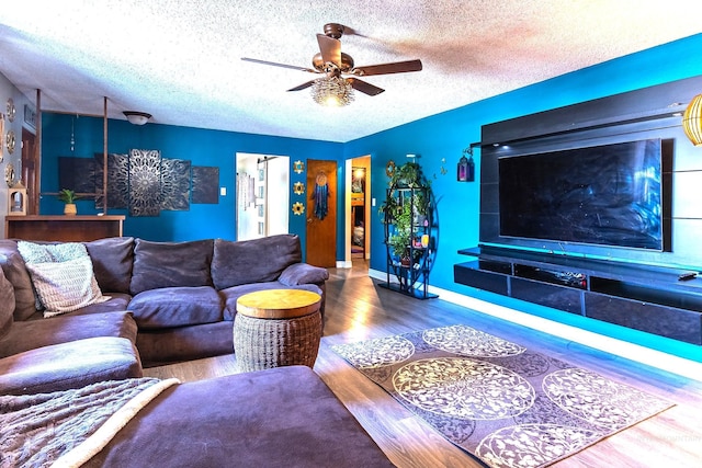 150 N 18 E, Mountain Home, ID 83647 - living area featuring a textured ceiling, wood finished floors, a ceiling fan, and baseboards