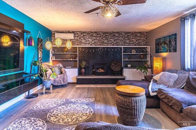 150 N 18 E, Mountain Home, ID 83647 - living room featuring a textured ceiling, a ceiling fan, wood finished floors, and a fireplace