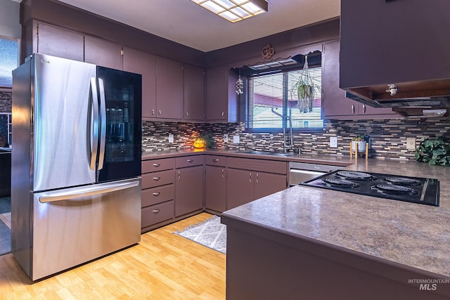 150 N 18 E, Mountain Home, ID 83647 - kitchen with freestanding refrigerator, a sink, light wood finished floors, tasteful backsplash, and extractor fan