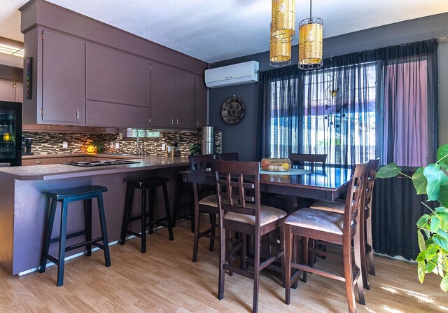 150 N 18 E, Mountain Home, ID 83647 - dining space featuring an AC wall unit, light wood-style floors, and a chandelier