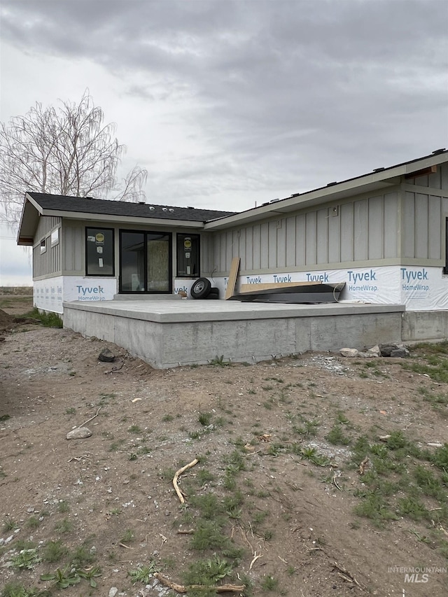 back of property featuring board and batten siding