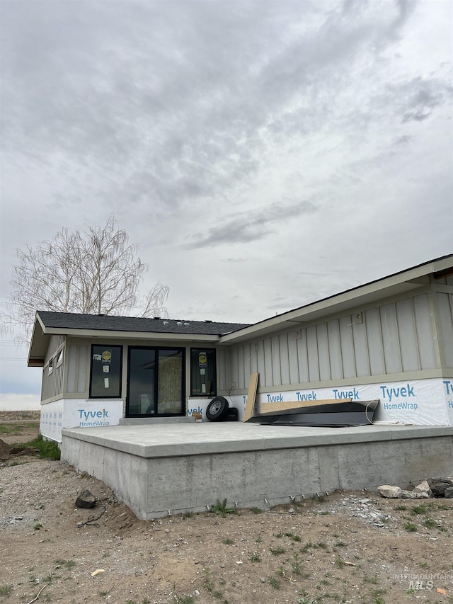 back of property featuring board and batten siding
