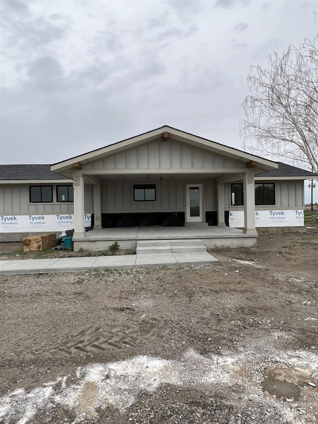 view of front of property featuring a carport, covered porch, and board and batten siding