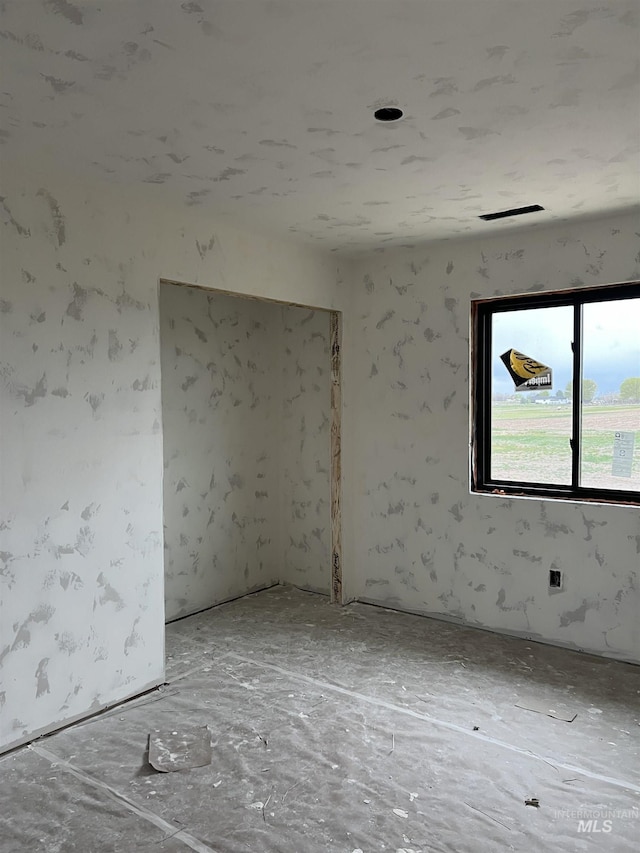 unfurnished room featuring visible vents