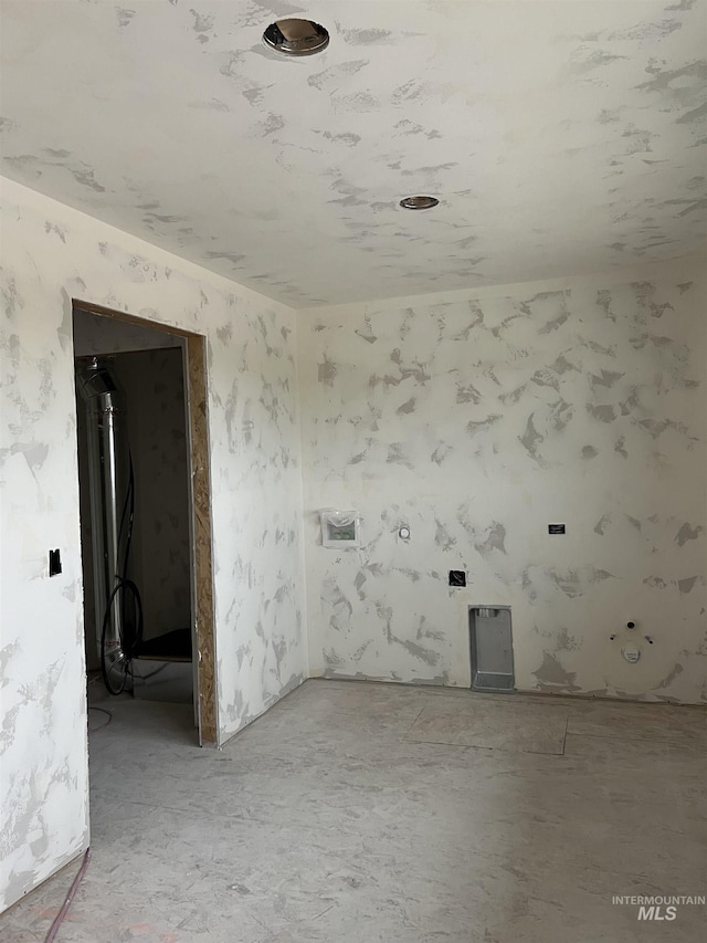unfurnished room with wallpapered walls