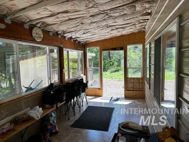 sunroom with vaulted ceiling and a wealth of natural light