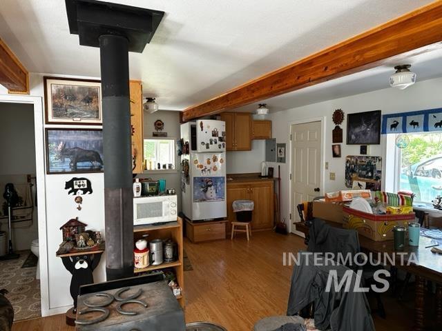 kitchen with hardwood / wood-style flooring and white appliances