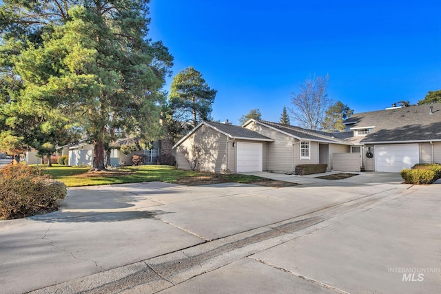 view of front of property with a front yard and a garage