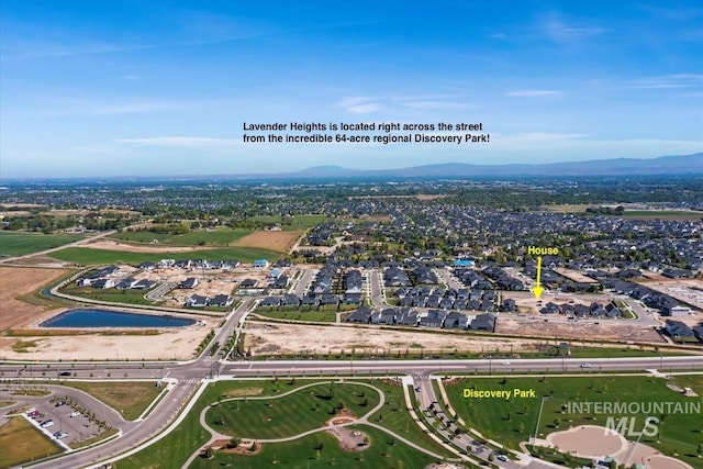 birds eye view of property with a mountain view