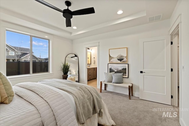 bedroom featuring recessed lighting, a raised ceiling, visible vents, and light colored carpet