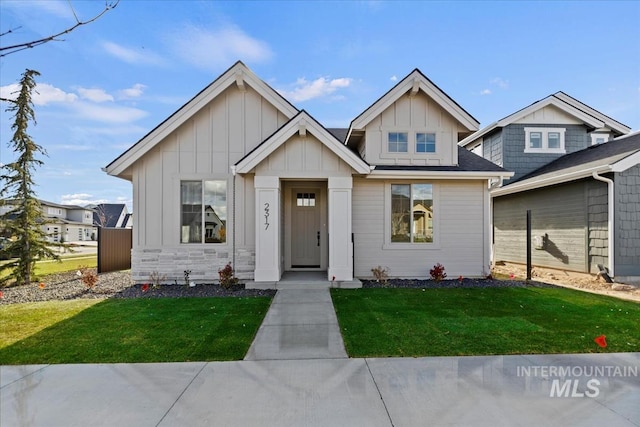 view of front of home featuring board and batten siding and a front lawn