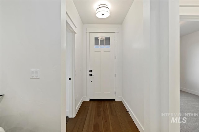 entryway with wood finished floors and baseboards