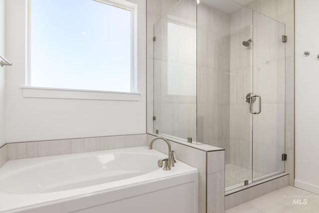 bathroom with a garden tub and a shower stall