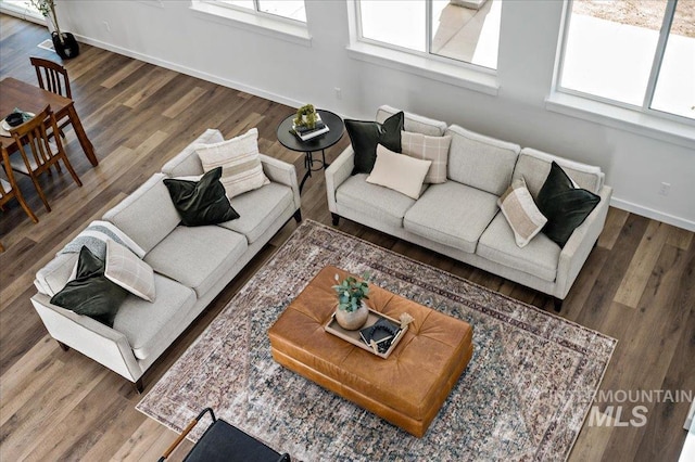 living area with wood finished floors and baseboards