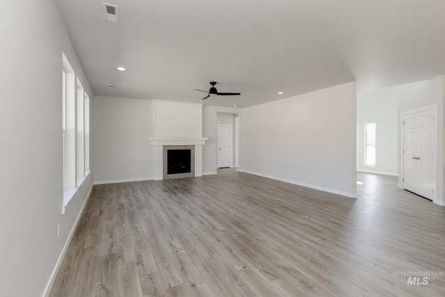 8592 N Ferris Ave, Boise, ID 83714 - unfurnished living room with ceiling fan, light wood-type flooring, baseboards, a fireplace, and recessed lighting