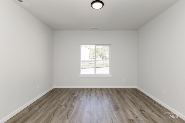 8592 N Ferris Ave, Boise, ID 83714 - empty room with wood finished floors and baseboards