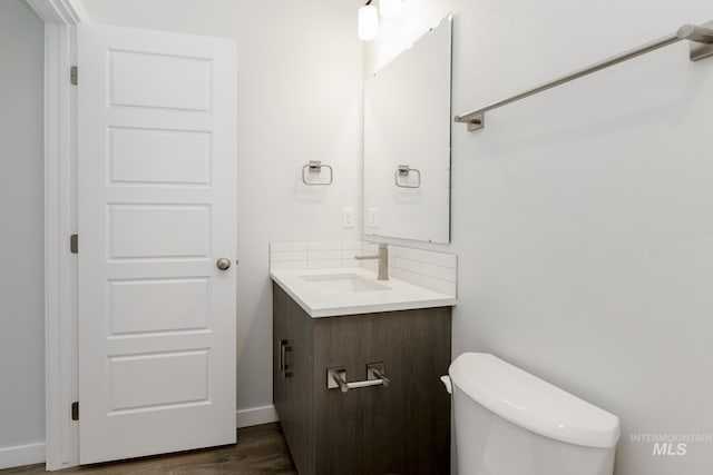 8592 N Ferris Ave, Boise, ID 83714 - bathroom with vanity, toilet, wood finished floors, and baseboards