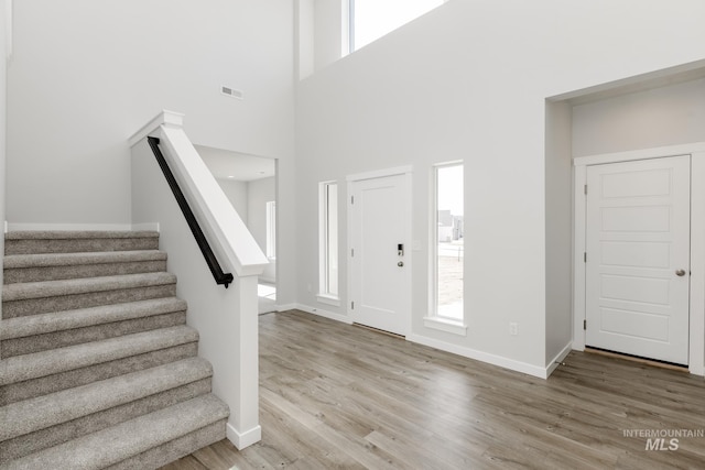 8592 N Ferris Ave, Boise, ID 83714 - entrance foyer featuring wood finished floors, healthy amount of natural light, baseboards, and a towering ceiling