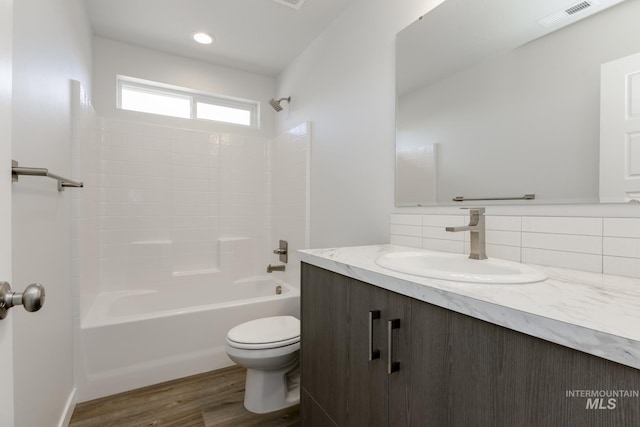 8592 N Ferris Ave, Boise, ID 83714 - bathroom with vanity, toilet, shower / bath combination, wood finished floors, and backsplash