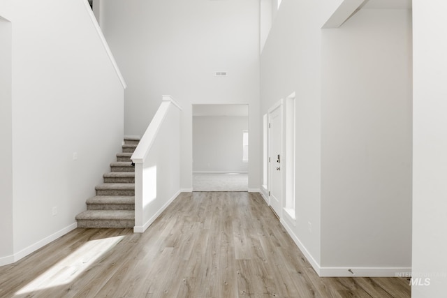 8592 N Ferris Ave, Boise, ID 83714 - entrance foyer with light wood finished floors, stairs, baseboards, and a high ceiling