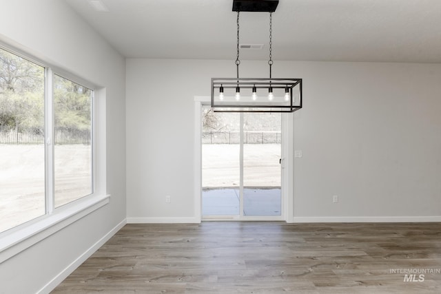 8592 N Ferris Ave, Boise, ID 83714 - unfurnished dining area with wood finished floors and baseboards