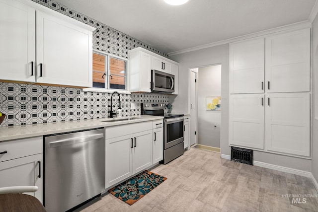 920 W Fort St, Boise, ID 83702 - kitchen with appliances with stainless steel finishes, a sink, light countertops, decorative backsplash, and white cabinets
