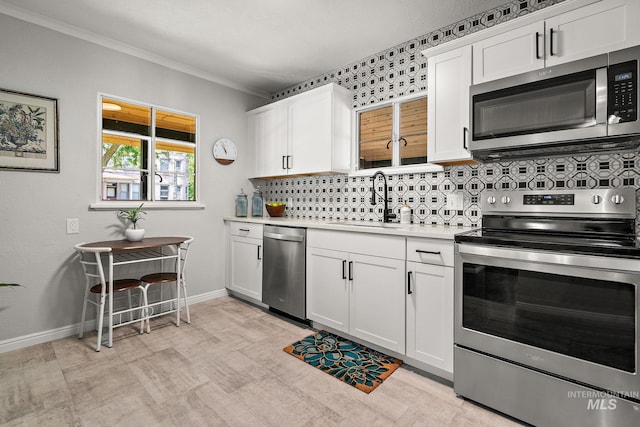 920 W Fort St, Boise, ID 83702 - kitchen featuring appliances with stainless steel finishes, a sink, decorative backsplash, light countertops, and white cabinets