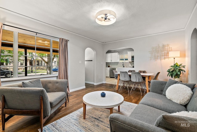 920 W Fort St, Boise, ID 83702 - living room featuring arched walkways, wood finished floors, a textured ceiling, and baseboards